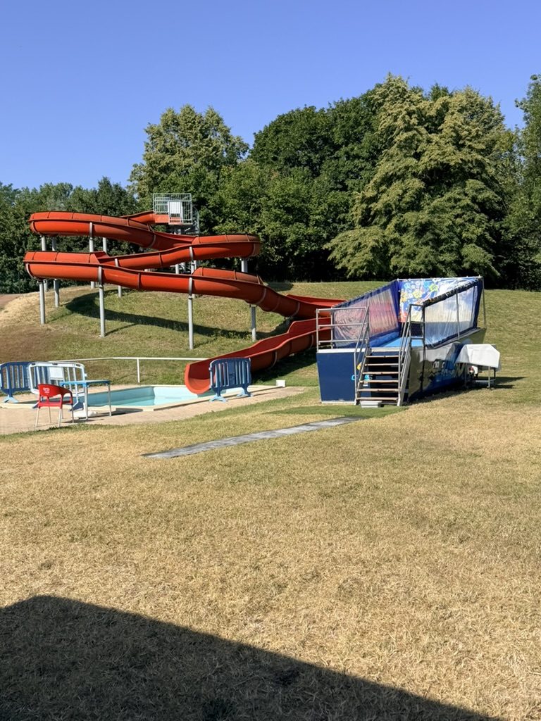 Simulateur de surf mobile à côté du bassin et des toboggans du parc aquatique